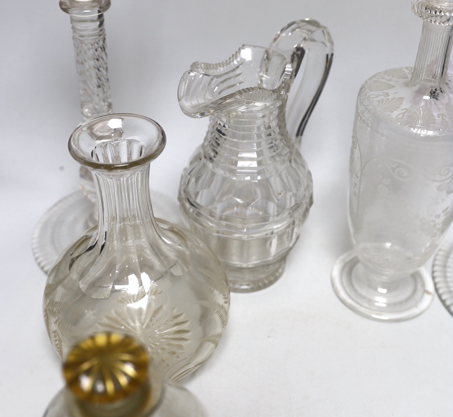 A group of 19th century and later glassware including an Edwardian decanter with floral etched decoration and a pair of glass candlesticks, the largest 29cm high